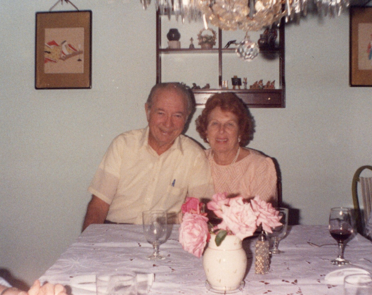 older couple sitting at a table smiling